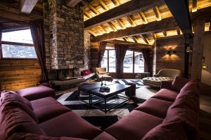 Large corner sofa in a romantic bedroom at Chalet Chêne, La Mourra Hotel village.