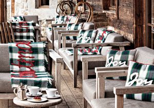 Cushions and chairs on terrace of Les Fermes de Marie Hotel.
